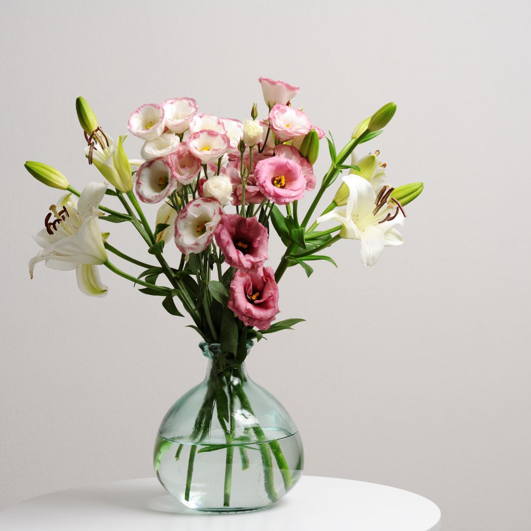 A bunch of flowers in a clear glass vase