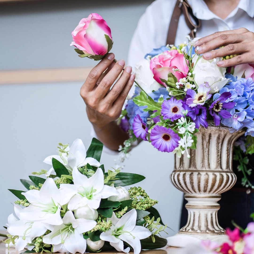 florist arranging bouquet in planter
